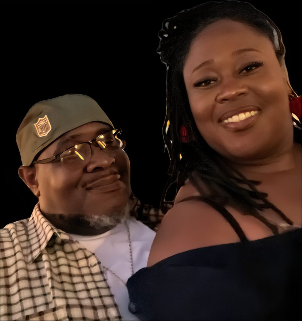 A man and a woman smiling warmly together.