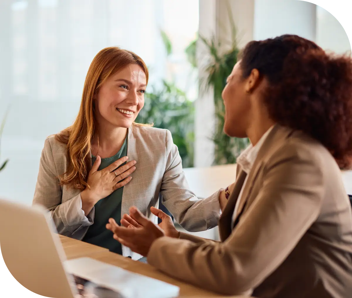 Office colleagues conversing, one expressing gratitude
